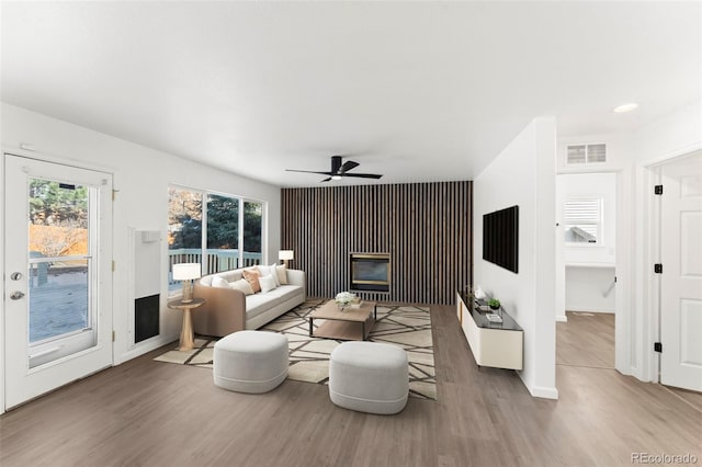 living room with hardwood / wood-style flooring and ceiling fan