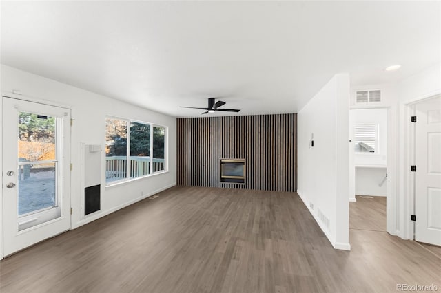 unfurnished living room featuring hardwood / wood-style flooring and ceiling fan