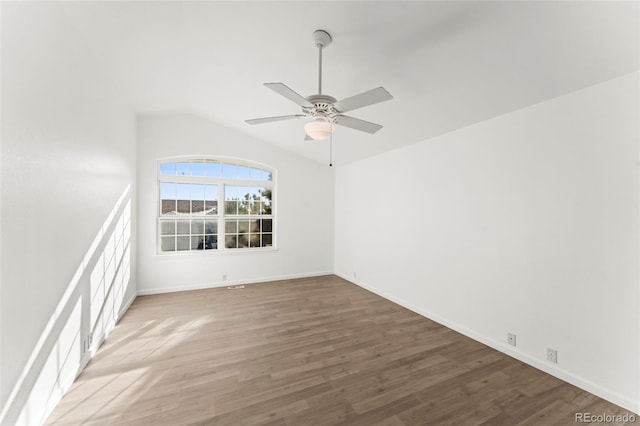 spare room with ceiling fan, lofted ceiling, and hardwood / wood-style flooring