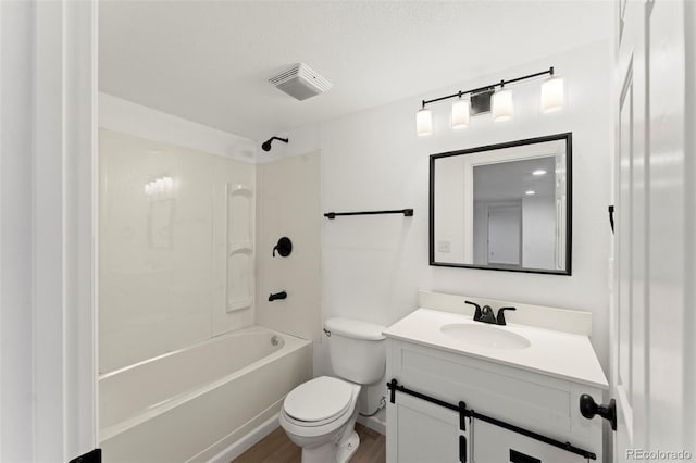 full bathroom featuring vanity, bathtub / shower combination, toilet, a textured ceiling, and wood-type flooring