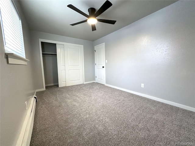 unfurnished bedroom featuring carpet floors, a closet, ceiling fan, and baseboard heating