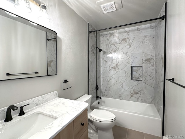 full bathroom with vanity, tile patterned flooring, toilet, and tiled shower / bath