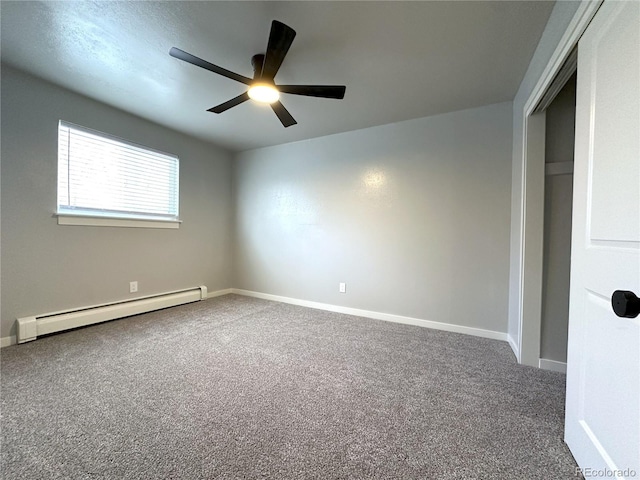 carpeted empty room with a baseboard radiator and ceiling fan