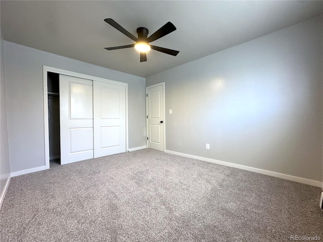 unfurnished bedroom featuring carpet floors, a closet, and ceiling fan