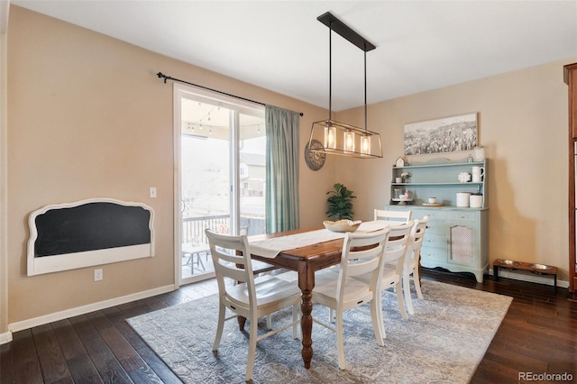 dining area featuring dark wood finished floors and baseboards