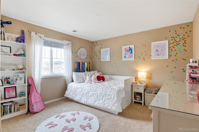 bedroom with light colored carpet and baseboards