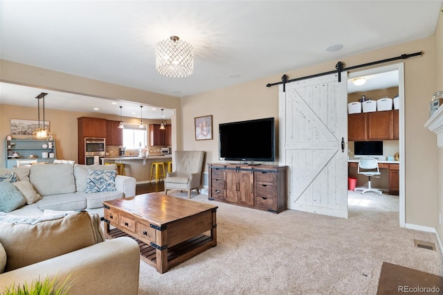 10995 Quintero St, Commerce City, CO 80022 - living area with a desk, light colored carpet, a barn door, and a chandelier