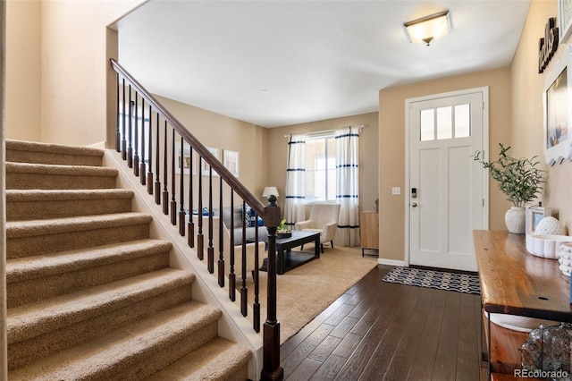 10995 Quintero St, Commerce City, CO 80022 - entrance foyer with stairway and dark wood-type flooring