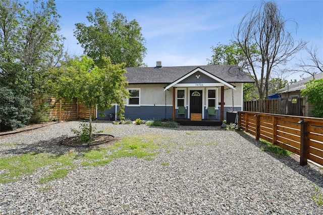 1456 Syracuse St, Denver, CO 80220 - view of front facade with stucco siding, a porch, and roof with shingles