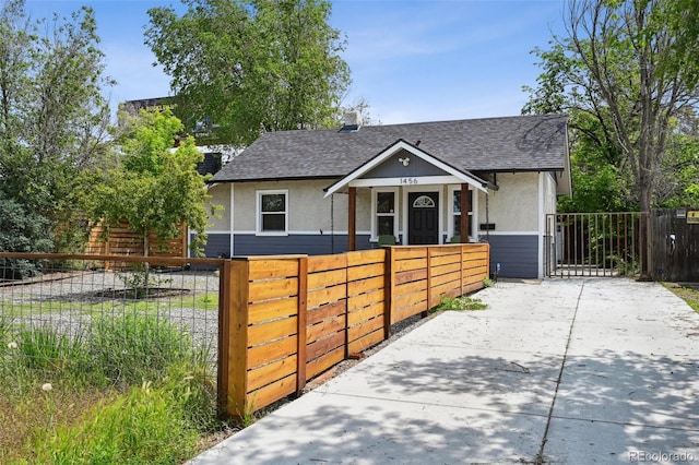 1456 Syracuse St, Denver, CO 80220 - bungalow-style house with a shingled roof, a gate, a fenced front yard, and stucco siding