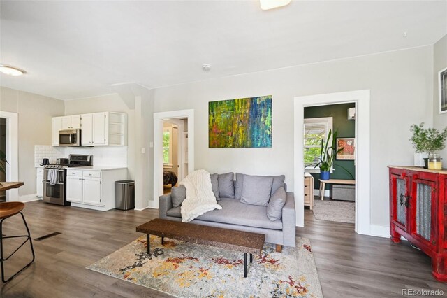 1456 Syracuse St, Denver, CO 80220 - living area featuring dark wood-style flooring and baseboards