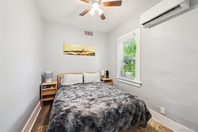 1456 Syracuse St, Denver, CO 80220 - bedroom with a wall mounted air conditioner, baseboards, a ceiling fan, and wood finished floors