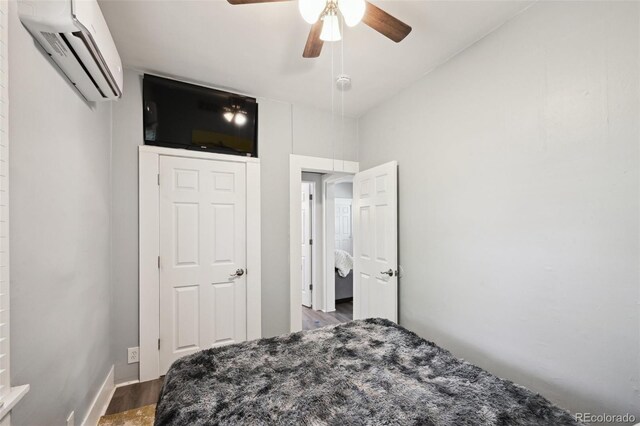 1456 Syracuse St, Denver, CO 80220 - bedroom featuring a wall mounted air conditioner, wood finished floors, and ceiling fan