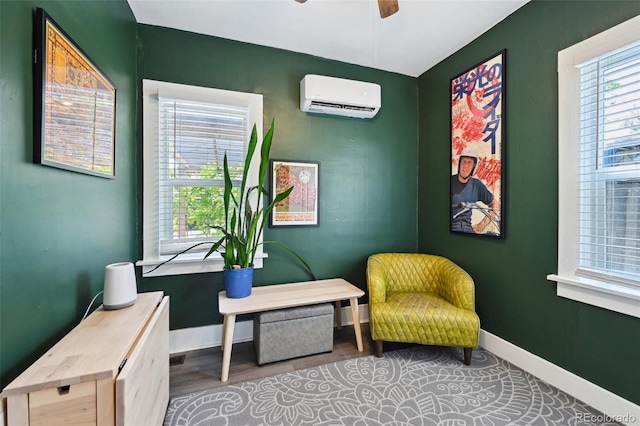 1456 Syracuse St, Denver, CO 80220 - sitting room featuring a wall mounted AC, plenty of natural light, a ceiling fan, and baseboards