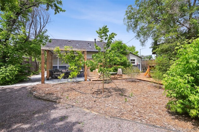 1456 Syracuse St, Denver, CO 80220 - rear view of house featuring a patio area and roof with shingles