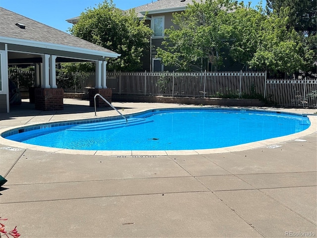 community pool featuring a patio area, fence, and a gazebo