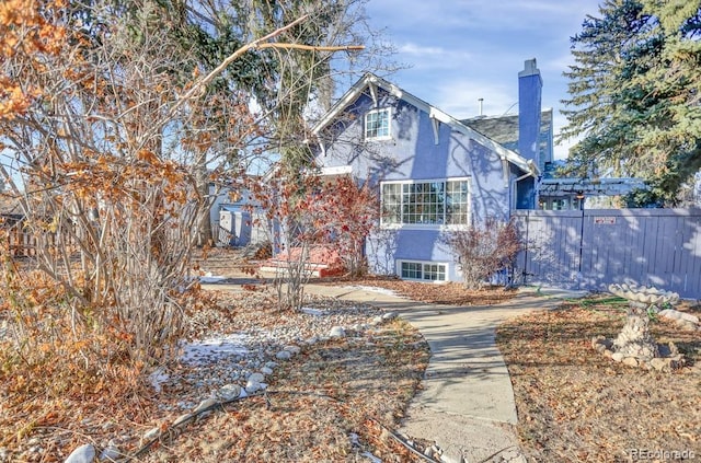 5725 W Mississippi Ave, Lakewood, CO 80226 - view of front of home featuring stucco siding and a chimney