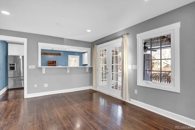 5725 W Mississippi Ave, Lakewood, CO 80226 - unfurnished living room featuring french doors, baseboards, healthy amount of natural light, and recessed lighting