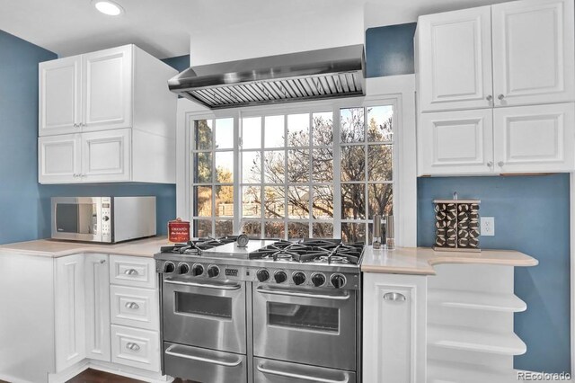 5725 W Mississippi Ave, Lakewood, CO 80226 - kitchen featuring stainless steel appliances, light countertops, white cabinets, recessed lighting, and wall chimney range hood