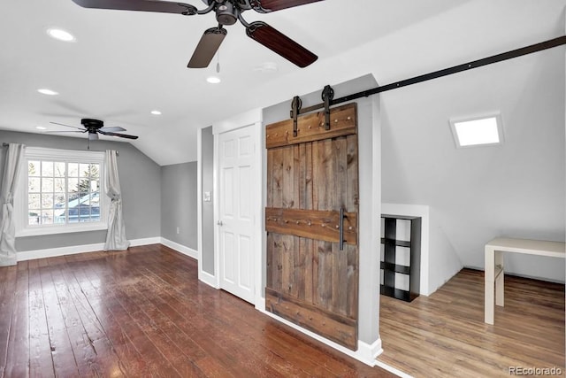 5725 W Mississippi Ave, Lakewood, CO 80226 - bonus room featuring ceiling fan, a barn door, hardwood / wood-style flooring, lofted ceiling, and baseboards