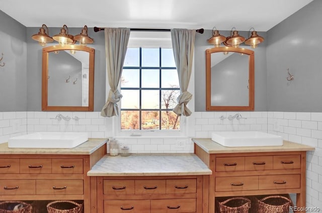 5725 W Mississippi Ave, Lakewood, CO 80226 - full bathroom featuring healthy amount of natural light, decorative backsplash, and two vanities