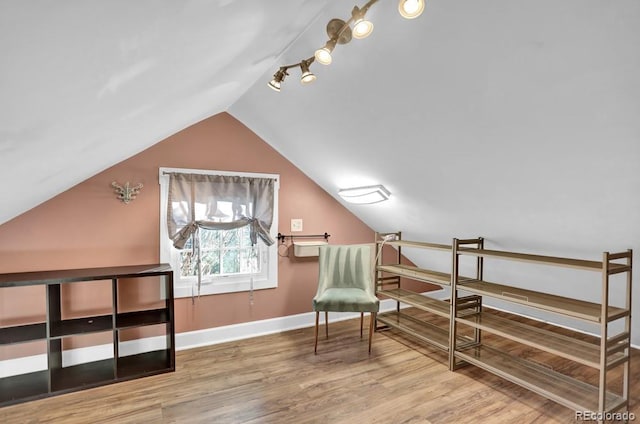 5725 W Mississippi Ave, Lakewood, CO 80226 - living area with vaulted ceiling, wood finished floors, baseboards, and track lighting