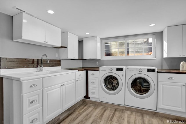 5725 W Mississippi Ave, Lakewood, CO 80226 - washroom with washer and dryer, cabinet space, light wood finished floors, and recessed lighting
