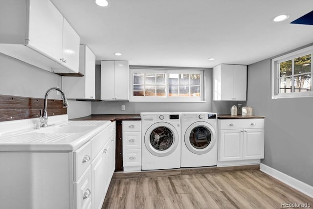 5725 W Mississippi Ave, Lakewood, CO 80226 - washroom with independent washer and dryer, cabinet space, light wood-style floors, recessed lighting, and baseboards