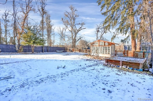 5725 W Mississippi Ave, Lakewood, CO 80226 - yard covered in snow with a wooden deck