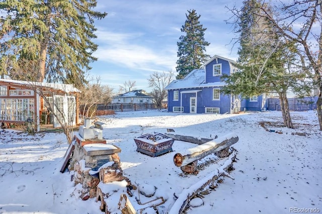 5725 W Mississippi Ave, Lakewood, CO 80226 - snowy yard with an outdoor fire pit and an outbuilding