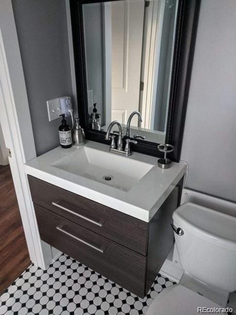 5725 W Mississippi Ave, Lakewood, CO 80226 - bathroom featuring vanity, toilet, and tile patterned flooring