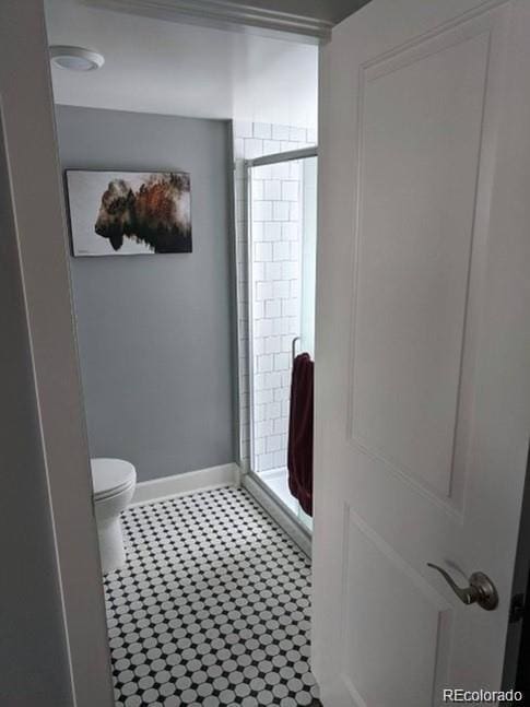 5725 W Mississippi Ave, Lakewood, CO 80226 - bathroom with a stall shower, toilet, and baseboards