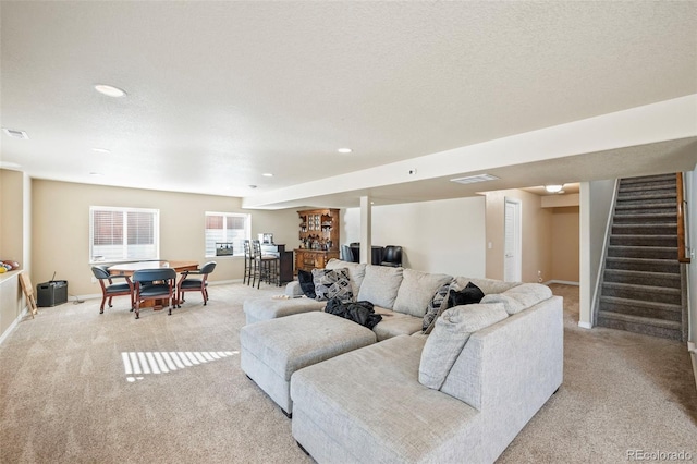 living room with light colored carpet and a textured ceiling