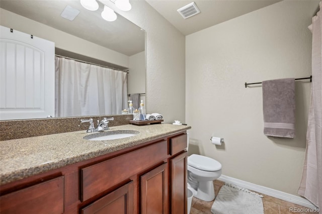 bathroom featuring vanity, toilet, and tile patterned floors