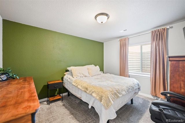 carpeted bedroom with a textured ceiling