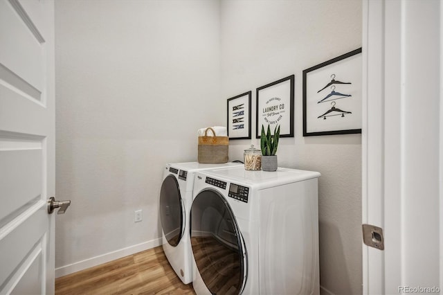 487 Interlocken Blvd Unit 104, Broomfield, CO 80021 - washroom featuring washing machine and dryer, light wood-style flooring, and baseboards
