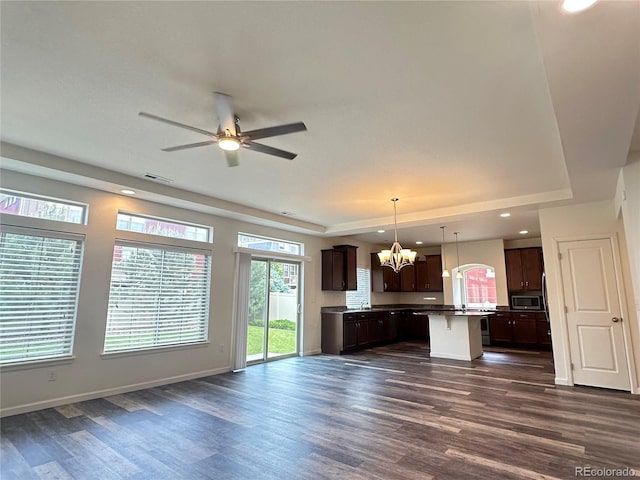 133 Poppy View Ln, Erie, CO 80516 - kitchen featuring stainless steel microwave, open floor plan, a raised ceiling, and recessed lighting