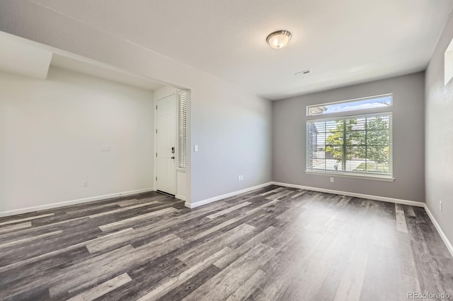 133 Poppy View Ln, Erie, CO 80516 - spare room featuring dark wood-style floors and baseboards