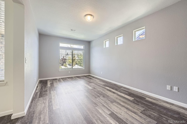 133 Poppy View Ln, Erie, CO 80516 - spare room with dark wood-type flooring and baseboards