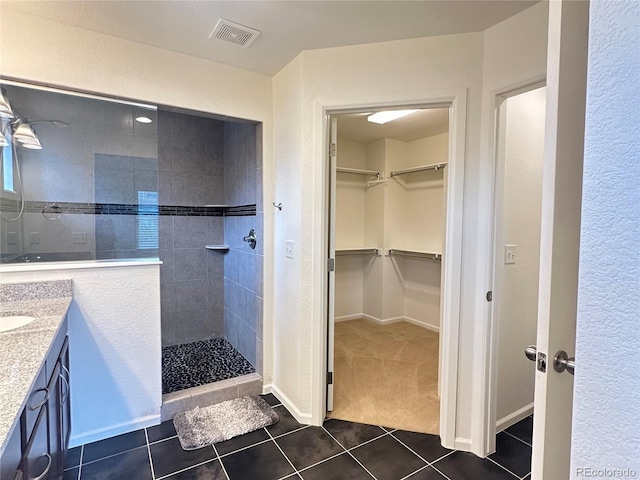 133 Poppy View Ln, Erie, CO 80516 - full bathroom with tile patterned floors, a walk in shower, vanity, and a spacious closet