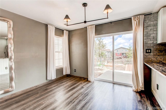 3607 Dinosaur St, Castle Rock, CO 80109 - unfurnished dining area with wood finished floors and a chandelier