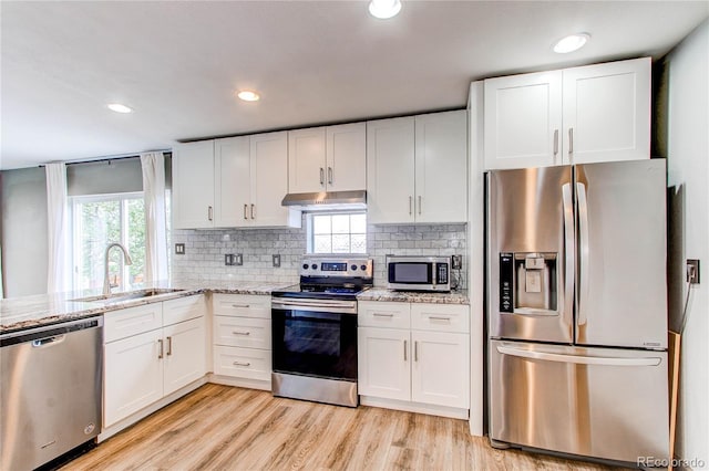 3607 Dinosaur St, Castle Rock, CO 80109 - kitchen with stainless steel appliances, a sink, under cabinet range hood, white cabinetry, and recessed lighting