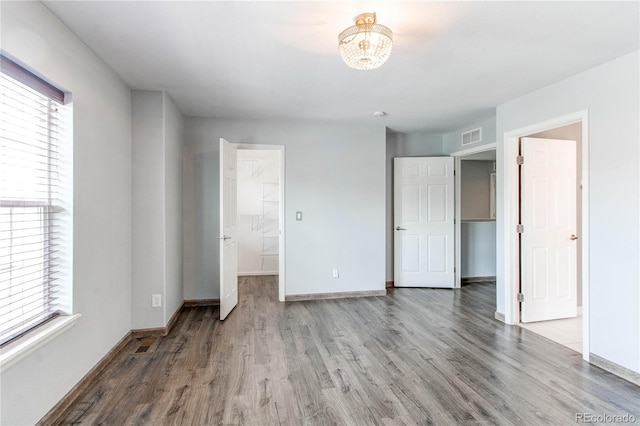 3607 Dinosaur St, Castle Rock, CO 80109 - unfurnished bedroom with wood finished floors, multiple windows, and baseboards