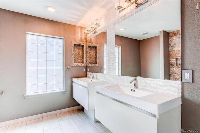 3607 Dinosaur St, Castle Rock, CO 80109 - full bathroom with healthy amount of natural light, two vanities, and baseboards