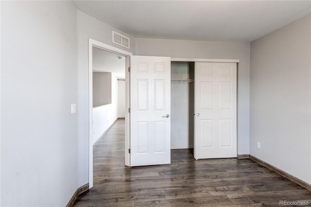 3607 Dinosaur St, Castle Rock, CO 80109 - unfurnished bedroom with dark wood finished floors, baseboards, and a closet