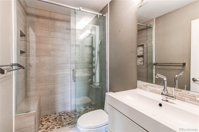 3607 Dinosaur St, Castle Rock, CO 80109 - full bath featuring a shower stall, toilet, vanity, backsplash, and a textured wall