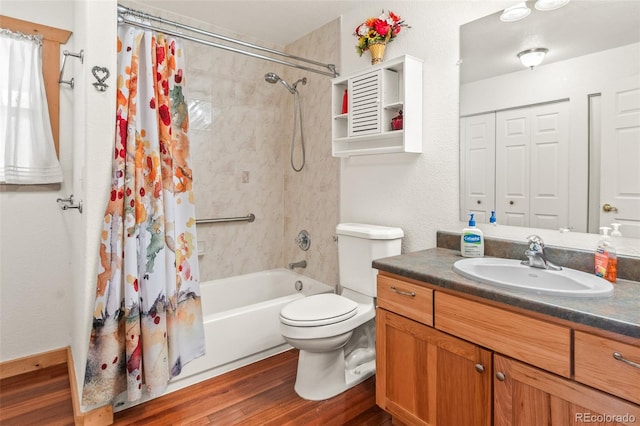 full bathroom with hardwood / wood-style floors, vanity, toilet, and shower / tub combo