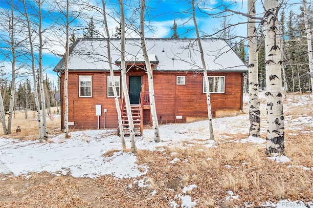 view of snow covered rear of property