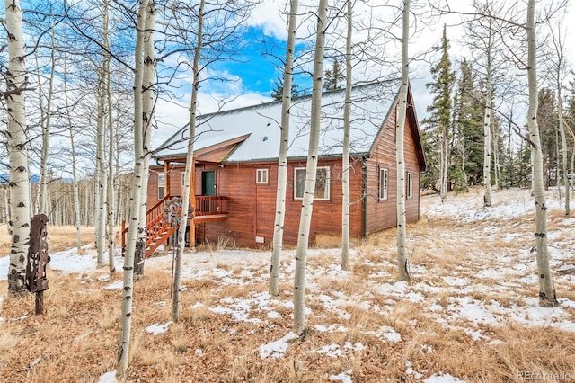 112 Apache Trl, Jefferson, CO 80456 - snow covered property featuring a shingled roof