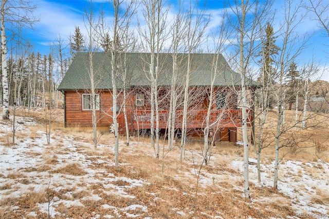 snow covered house with a deck